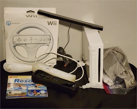 Wii w/ 2 controllers, Nunchuk, Wheel, and Games- (White)