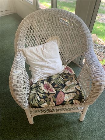 White Wicker Chair With Chair Pad and White Throw Pillow