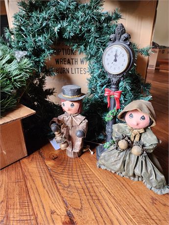 Large lit wreaths, carolers and pillows