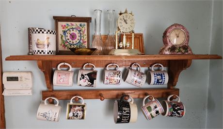 Shelf of mugs, clocks, etc