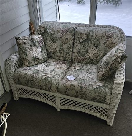 White Wicker Loveseat With Floral Pattern Cushions