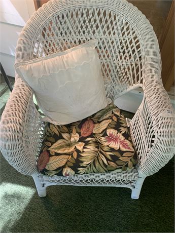 White Wicker Chair With Chair Pad and White Throw Pillow