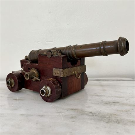 Old Brass Cannon on Wood Base